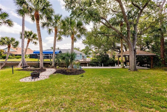 view of yard featuring an outdoor fire pit and a gazebo