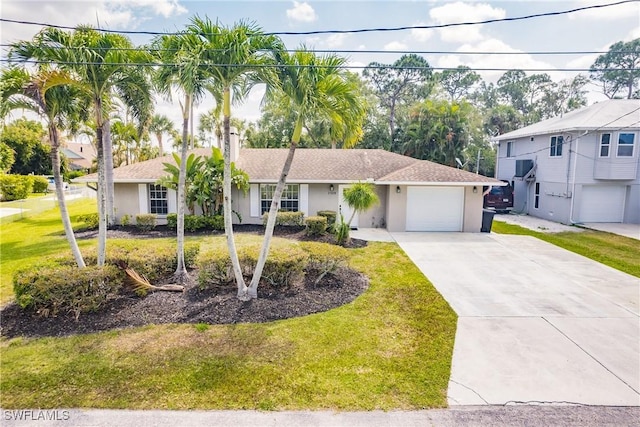 view of front of home with a front yard and a garage