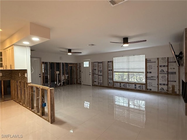 interior space with tile patterned floors and ceiling fan