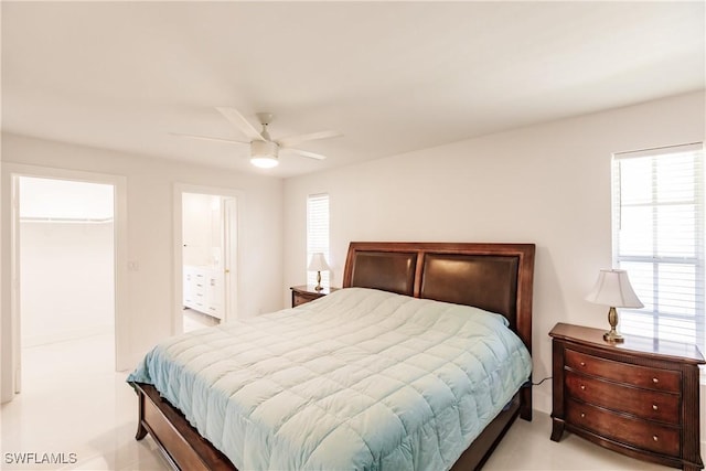 bedroom with multiple windows, a closet, ceiling fan, and a walk in closet