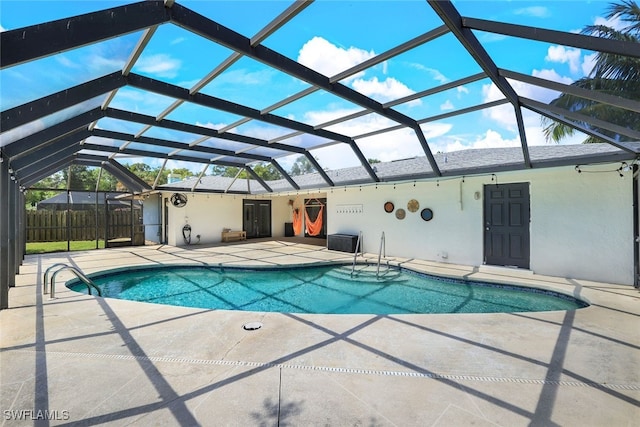 view of swimming pool with a lanai and a patio