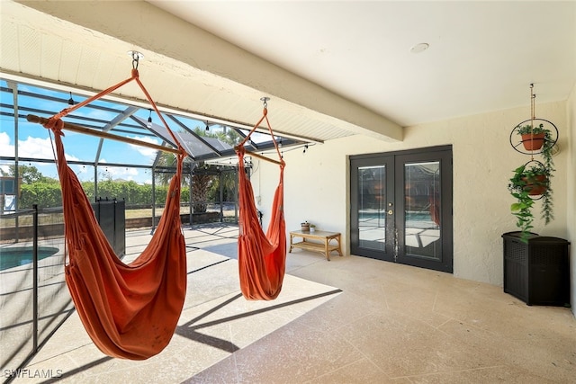 view of patio / terrace featuring french doors and a lanai