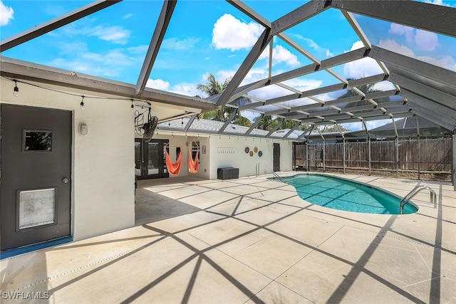 view of pool with a lanai and a patio