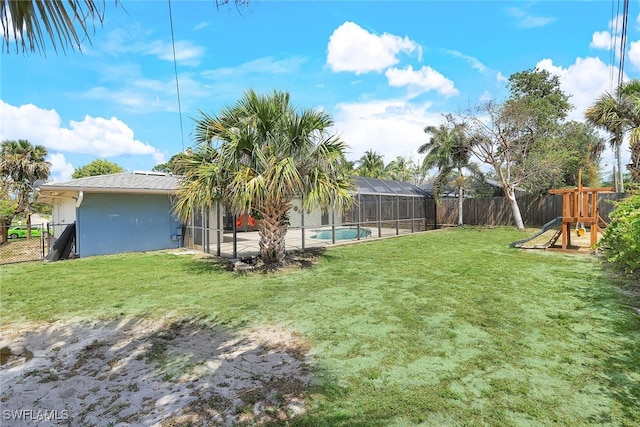 view of yard featuring a patio, a fenced in pool, glass enclosure, and a playground