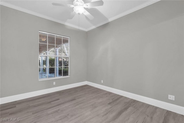 spare room with crown molding, wood-type flooring, and ceiling fan