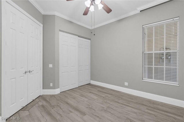 unfurnished bedroom with crown molding, ceiling fan, and light wood-type flooring