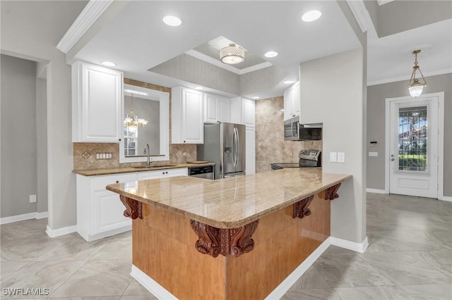 kitchen with white cabinetry, stainless steel appliances, a kitchen bar, and kitchen peninsula