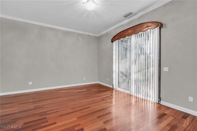 unfurnished room with hardwood / wood-style flooring and crown molding