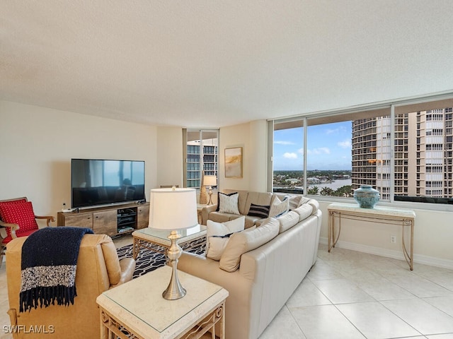 living room featuring floor to ceiling windows and light tile patterned floors