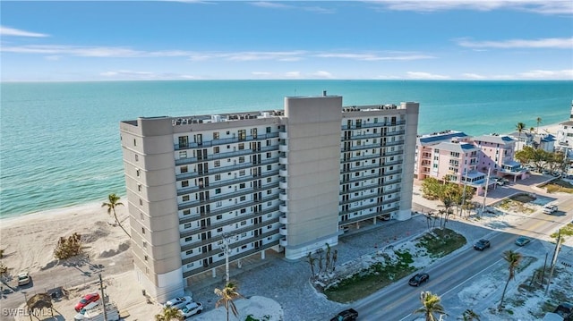 birds eye view of property featuring a beach view and a water view