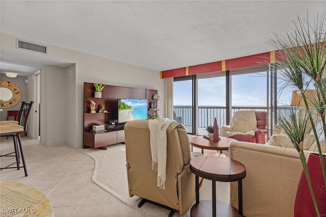 tiled living room featuring expansive windows