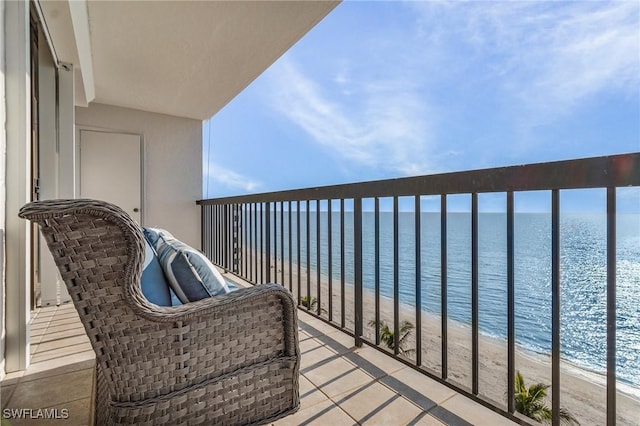 balcony with a beach view and a water view