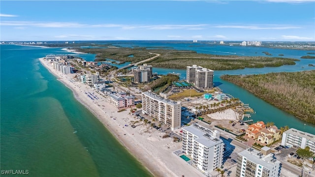 birds eye view of property with a water view and a view of the beach