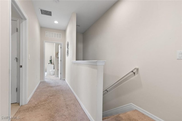 hallway featuring light carpet