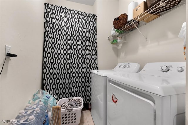 laundry room featuring light tile patterned floors and washing machine and dryer