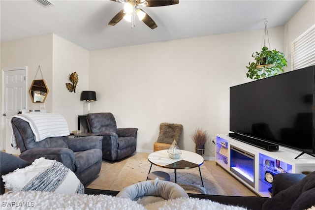 living room with tile patterned floors and ceiling fan