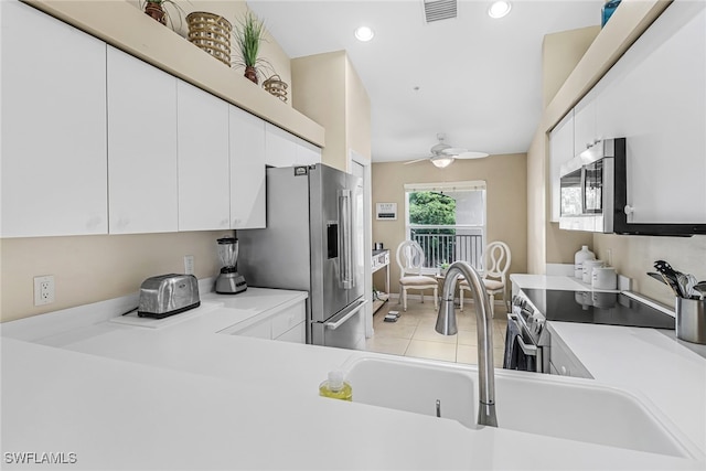 kitchen with ceiling fan, white cabinetry, and appliances with stainless steel finishes