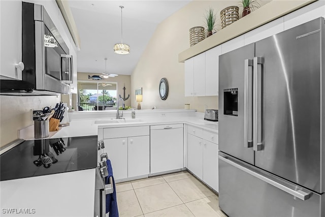 kitchen with pendant lighting, dishwasher, white cabinets, high end fridge, and lofted ceiling