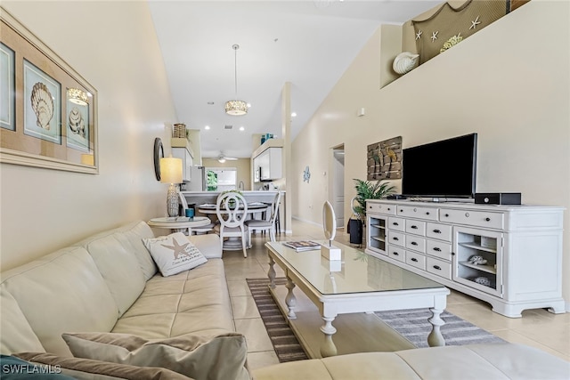 living room with a towering ceiling and light tile patterned floors