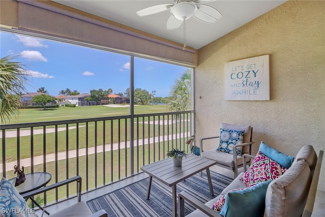 sunroom / solarium featuring ceiling fan