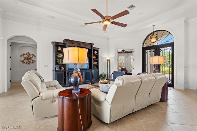 tiled living room featuring ornamental molding, a raised ceiling, and ceiling fan