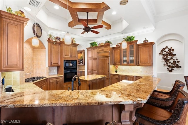 kitchen with backsplash, decorative light fixtures, black appliances, and kitchen peninsula