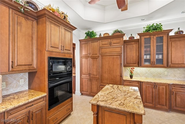 kitchen featuring light tile patterned flooring, black appliances, ceiling fan, light stone countertops, and backsplash