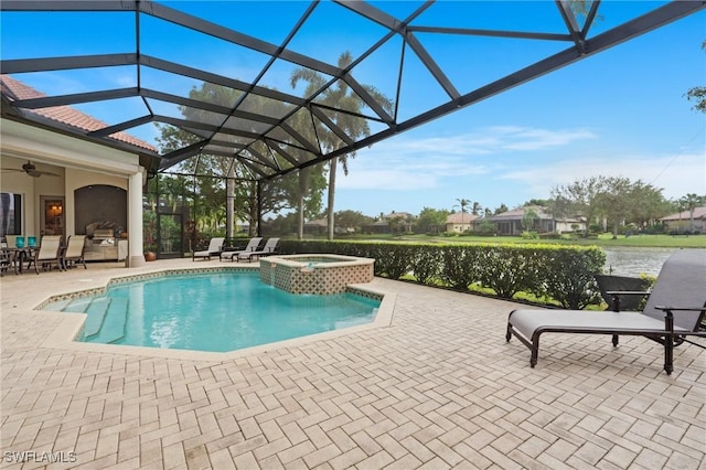 view of pool with a water view, glass enclosure, an in ground hot tub, ceiling fan, and a patio