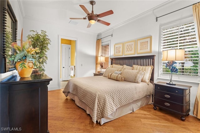 bedroom featuring multiple windows, crown molding, ceiling fan, and light wood-type flooring