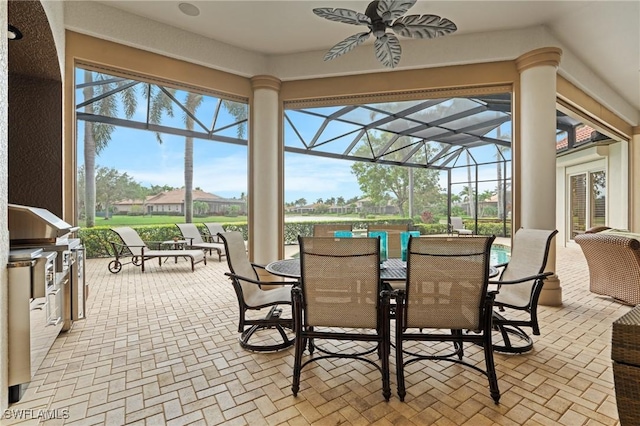 sunroom / solarium featuring ceiling fan