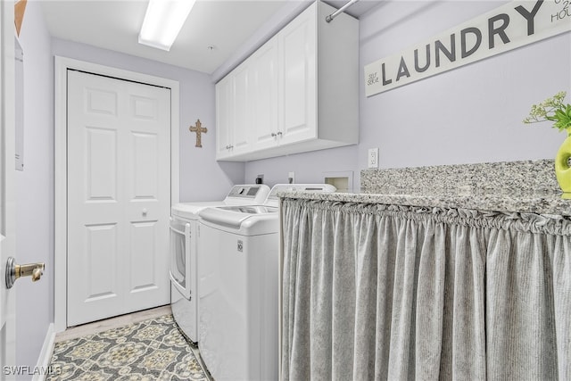 laundry area with cabinets and washer and clothes dryer