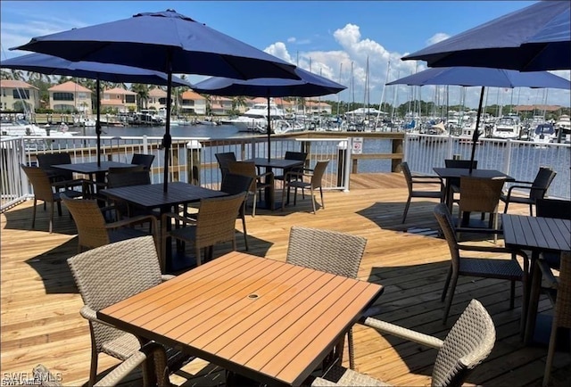 dock area featuring a water view and outdoor dining area