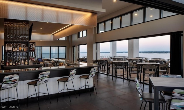 kitchen featuring a water view and a towering ceiling