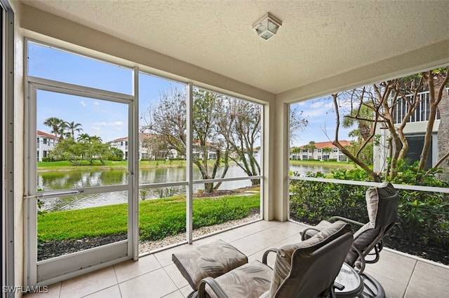 sunroom with a wealth of natural light and a water view