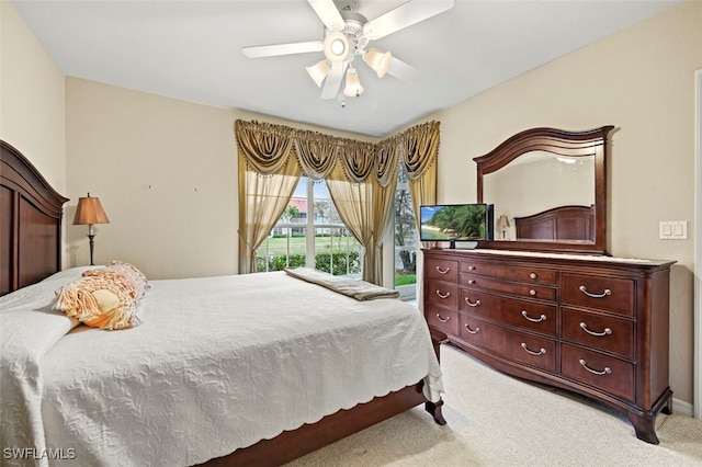 bedroom with ceiling fan, access to exterior, and light carpet