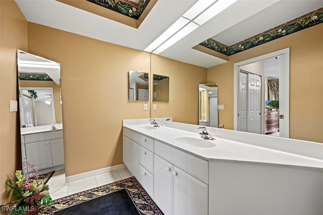 bathroom featuring vanity, tile patterned flooring, and a skylight