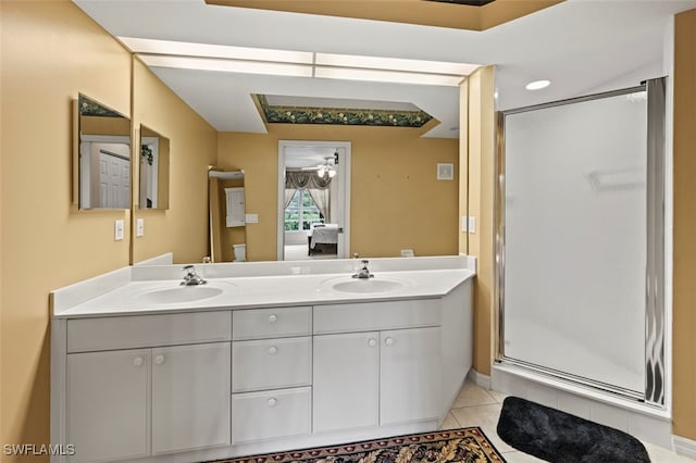 bathroom featuring tile patterned flooring, vanity, and walk in shower