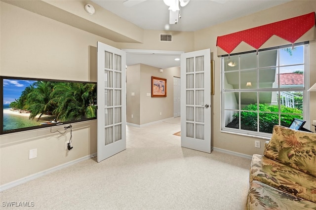 sitting room featuring carpet, ceiling fan, and french doors