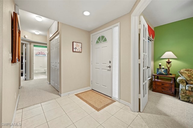 view of carpeted foyer entrance