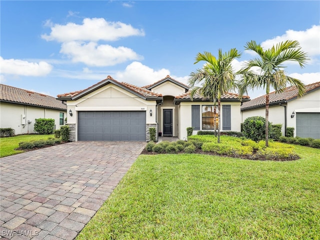 mediterranean / spanish-style home with a garage and a front yard