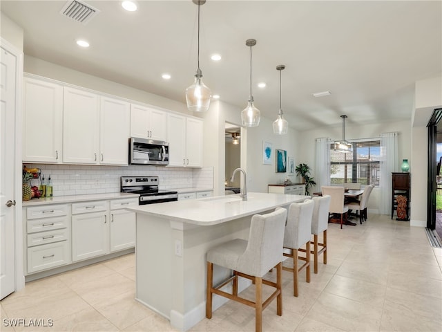 kitchen with white cabinetry, appliances with stainless steel finishes, and sink