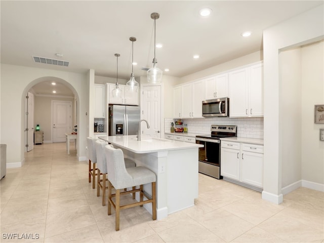 kitchen featuring white cabinetry, sink, an island with sink, and appliances with stainless steel finishes