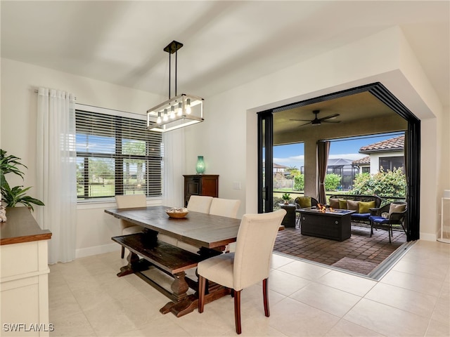 dining area featuring an inviting chandelier, a healthy amount of sunlight, and light tile patterned flooring