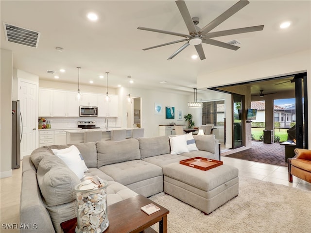 living room with light tile patterned floors and ceiling fan