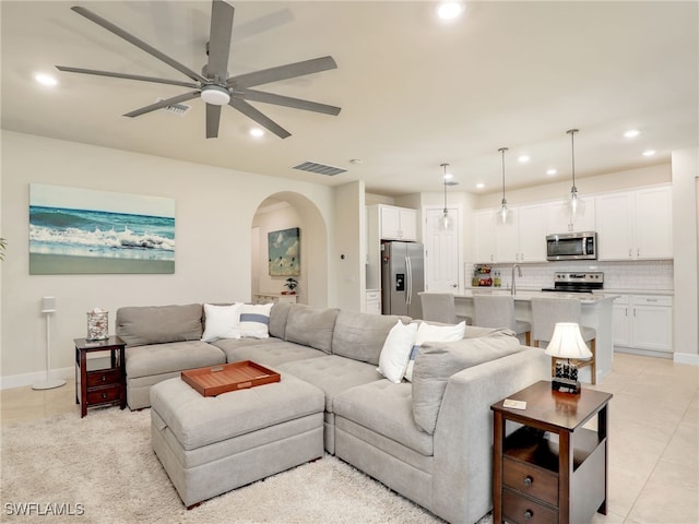 living room with light tile patterned floors and ceiling fan