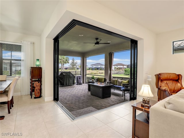 tiled living room featuring a healthy amount of sunlight and ceiling fan