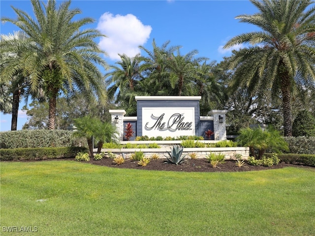 community sign featuring a lawn