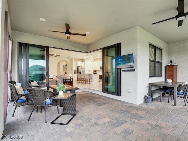 view of patio / terrace with an outdoor living space and ceiling fan