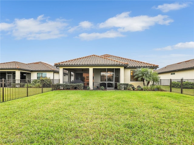 back of house featuring a sunroom and a yard