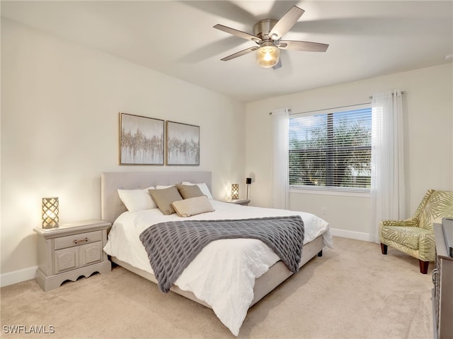 bedroom featuring light carpet and ceiling fan